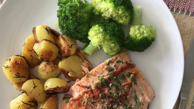 Plate of potatoes, salmon, and broccoli