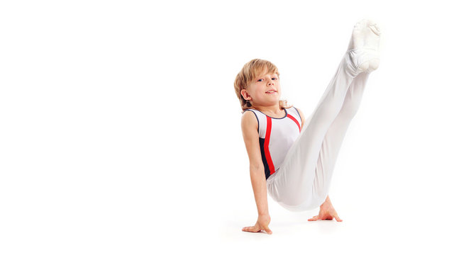Happy little boy doing gymnastics isolated on white background
