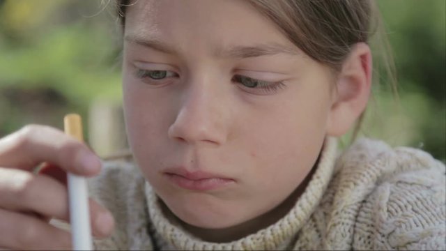 Portrait of a boy with a cigarette in his hand. Anti tobacco video. For a healthy lifestyle.
