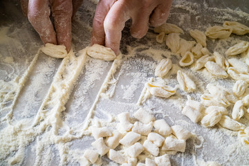 Italian woman making traditional fresh homemade pasta on a marble table - 144385335