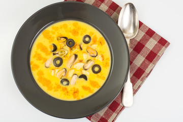 Spicy cream soup with mussels, curry and olives