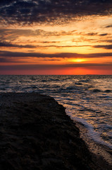 Cloudy summer sunset at sea beach