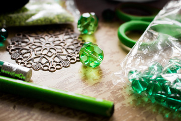 Still life of glass beads at working table.