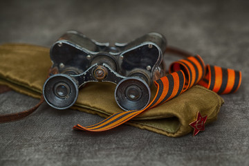 Military binoculars, soldier field cap, George Ribbon. Still life for the Victory Day - may 9