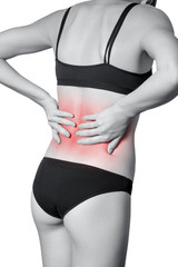 Closeup view of a young woman with pain in back.  isolated on white background. Black and white photo with red dot.