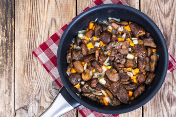 Mushrooms, onions, carrots on frying pan