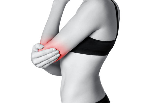 Closeup view of a young woman with elbow pain.  isolated on white background. Black and white photo with red dot.