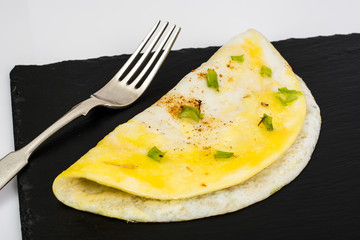 Fried eggs with mushrooms on black stone