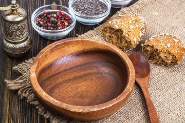 Empty wooden bowl and spoon for eating on old boards