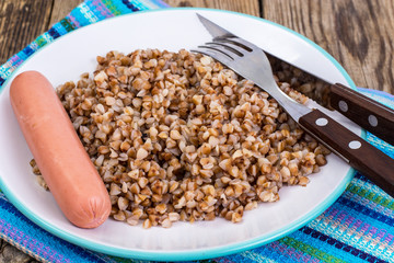 Sausage with garnish of buckwheat