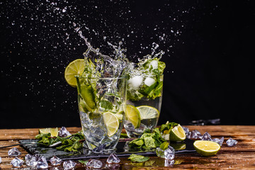 Glasses with drink, splashes, lime