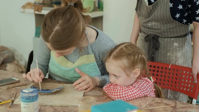 clay potter hands wheel pottery work workshop teacher and girl pupil 4k