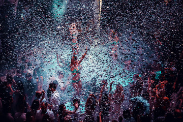 Night club dj party people enjoy of music dancing sound with colorful light with Smoke Machine and lights show. Hands up in the earth.
