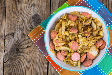Fried cabbage with sausage. Top view