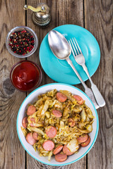 Fried cabbage with sausage. Top view