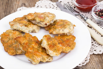 Fried chicken cutlets on white plate