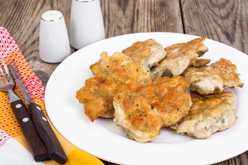Fried chicken cutlets on white plate