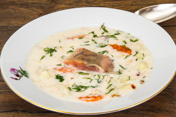 Milk cream soup with vegetables and trout