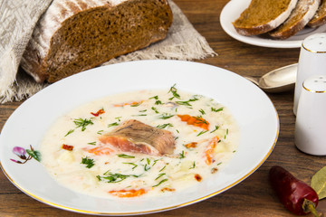 Milk cream soup with vegetables and trout