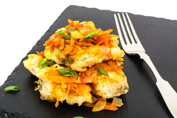 Greek style roast fish on black stone plate