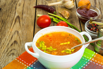 Soup in white bowl on wooden background.