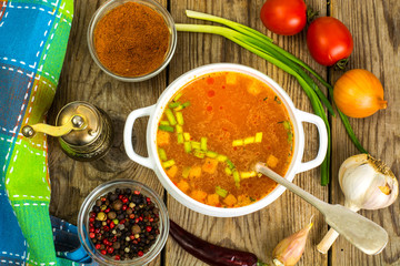 Soup in white bowl on wooden background.