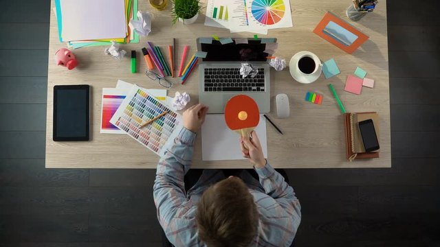 Man relieving tension and looking for inspiration by kicking up ping-pong ball