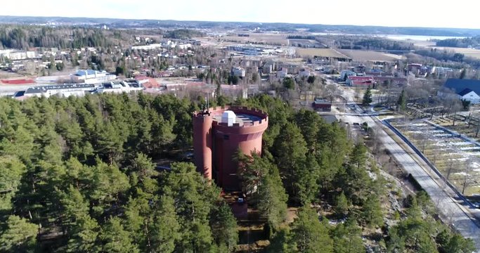 Halikko watertower, Cinema 4k rising above view aerial of Halikko water tower, on a sunny spring day, in Salo, Finland