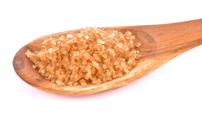 Brown sugar in a wooden spoon on a white background