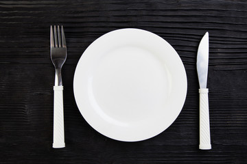 wooden  black plate fork knife top view