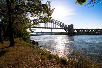 The Hell Gate Bridge over the river at Astoria park, New York