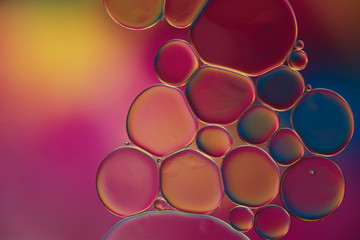 drops of oil and air bubbles on the water