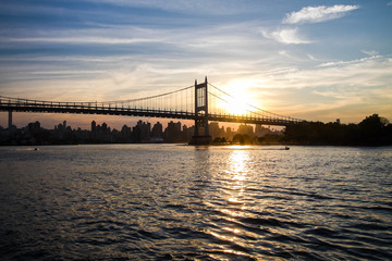Fototapeta na wymiar Triborough bridge over the river and sunset, New York