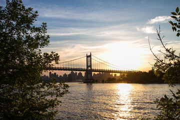 Fototapeta na wymiar Triborough bridge over the river and sunset, New York