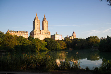 Buildings in Manhattan with lake and blue sky at Central Park