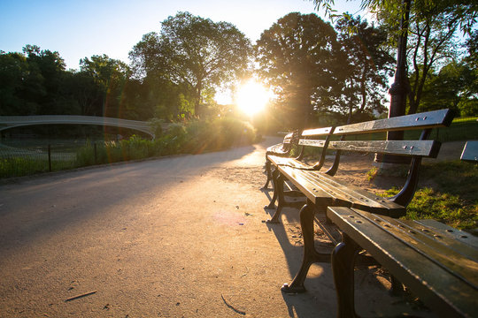 Bow Bridge And Park Bench On The Walkway At Central Park With Sunrise