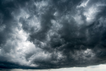 Obraz na płótnie Canvas Background of dark clouds before a thunder-storm ,sunlight through very dark clouds background ,White Hole in the Whirlwind of dark storm clouds