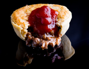 Meat pie on reflective surface
