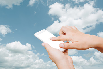 Woman hand hold and touch screen smart phone on cloud background