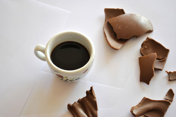 Cracked Eggs chocolate and cup of coffee. Espresso. White background.