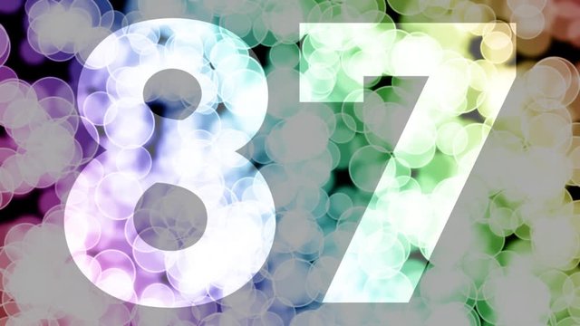 Eighty seven to eighty eight years birthday fade in/out animation with color gradient moving bokeh background. Animation: 90 frames still with number, 180 fade out, 30 clear, 180 fade in, 300 still.
