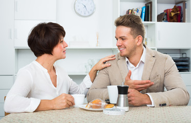 Fototapeta premium woman and man drinking tea with cakes