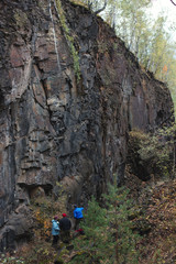 Technogenic rock fracture in the autumn forest.