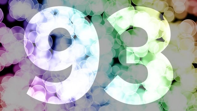 Ninety three to ninety four years birthday fade in/out animation with color gradient moving bokeh background. Animation: 90 frames still with number, 180 fade out, 30 clear, 180 fade in, 300 still.