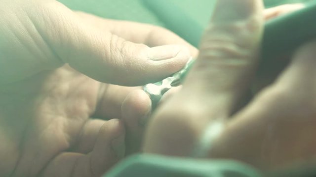 Close up of a dental technician making partial ceramic crown in dental lab