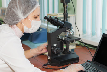 Woman scientist looking in a microscope