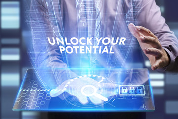 Fototapeta na wymiar Business, Technology, Internet and network concept. Young businessman working on a virtual screen of the future and sees the inscription: Unlock your potential