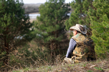 A man in the forest observes nature