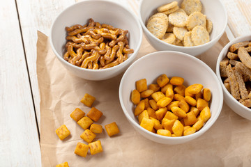 Pretzels in bowls on wooden table from above