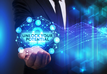 Business, Technology, Internet and network concept. Young businessman working on a virtual screen of the future and sees the inscription: Unlock your potential